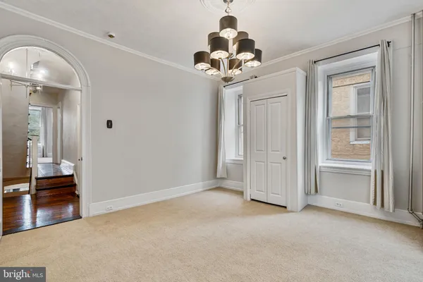 a view of a chandelier fan and entryway