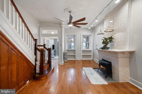 a living room with wooden floors and a fireplace