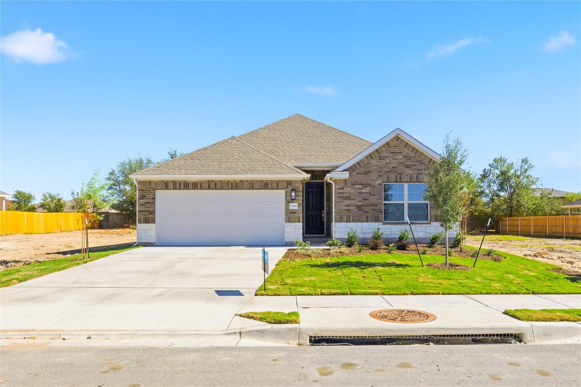 13609 Barn Chime Street Elgin, TX 78621 - Photo 1 of 14 a view of a house with a big yard and large trees