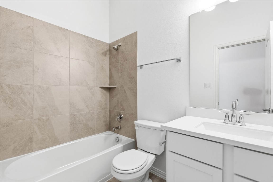 13609 Barn Chime Street Elgin, TX 78621 - Photo 10 of 14 a bathroom with a sink toilet and shower