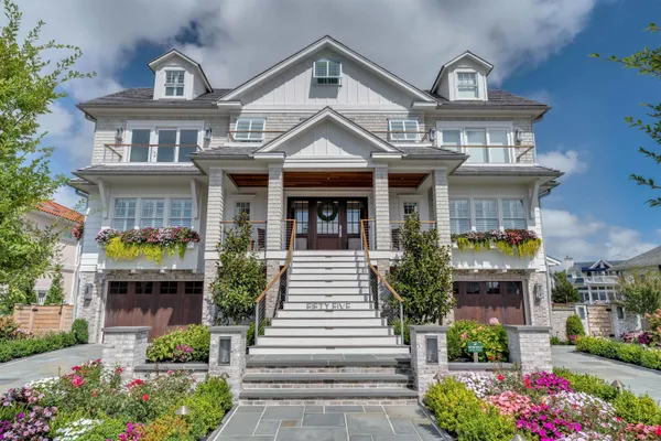 a front view of a house with plants and garden