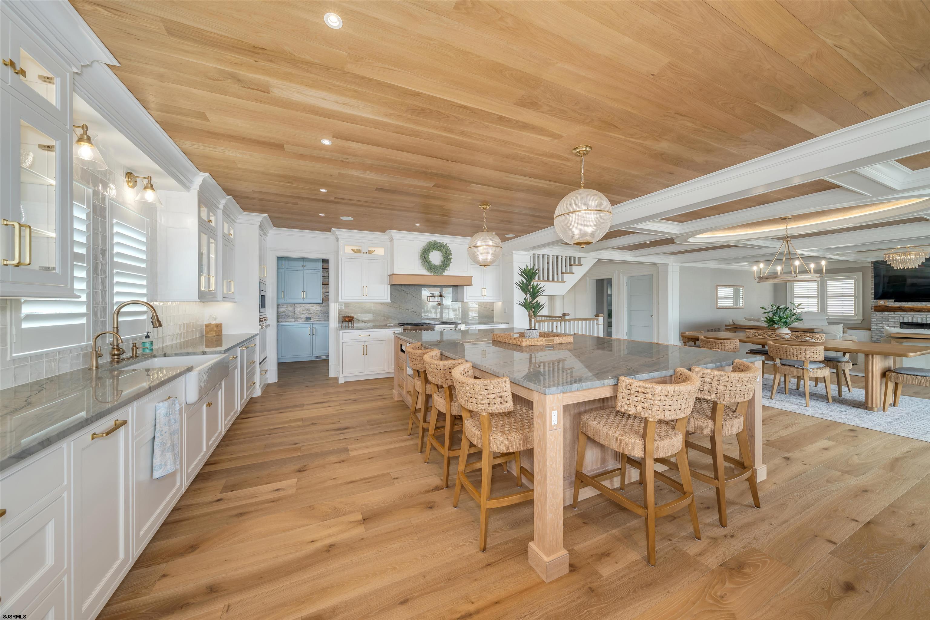 55 Walnut Road Ocean City, NJ 08226 - Photo 28 of 97 a dining hall with stainless steel appliances kitchen island granite countertop a table chairs and a oven