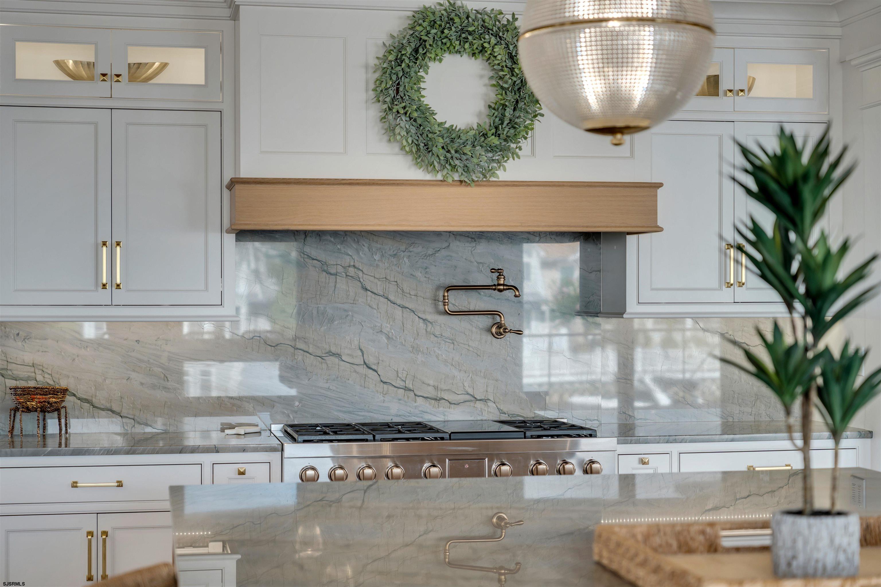 55 Walnut Road Ocean City, NJ 08226 - Photo 32 of 97 a kitchen with a potted plant on the counter and cabinets