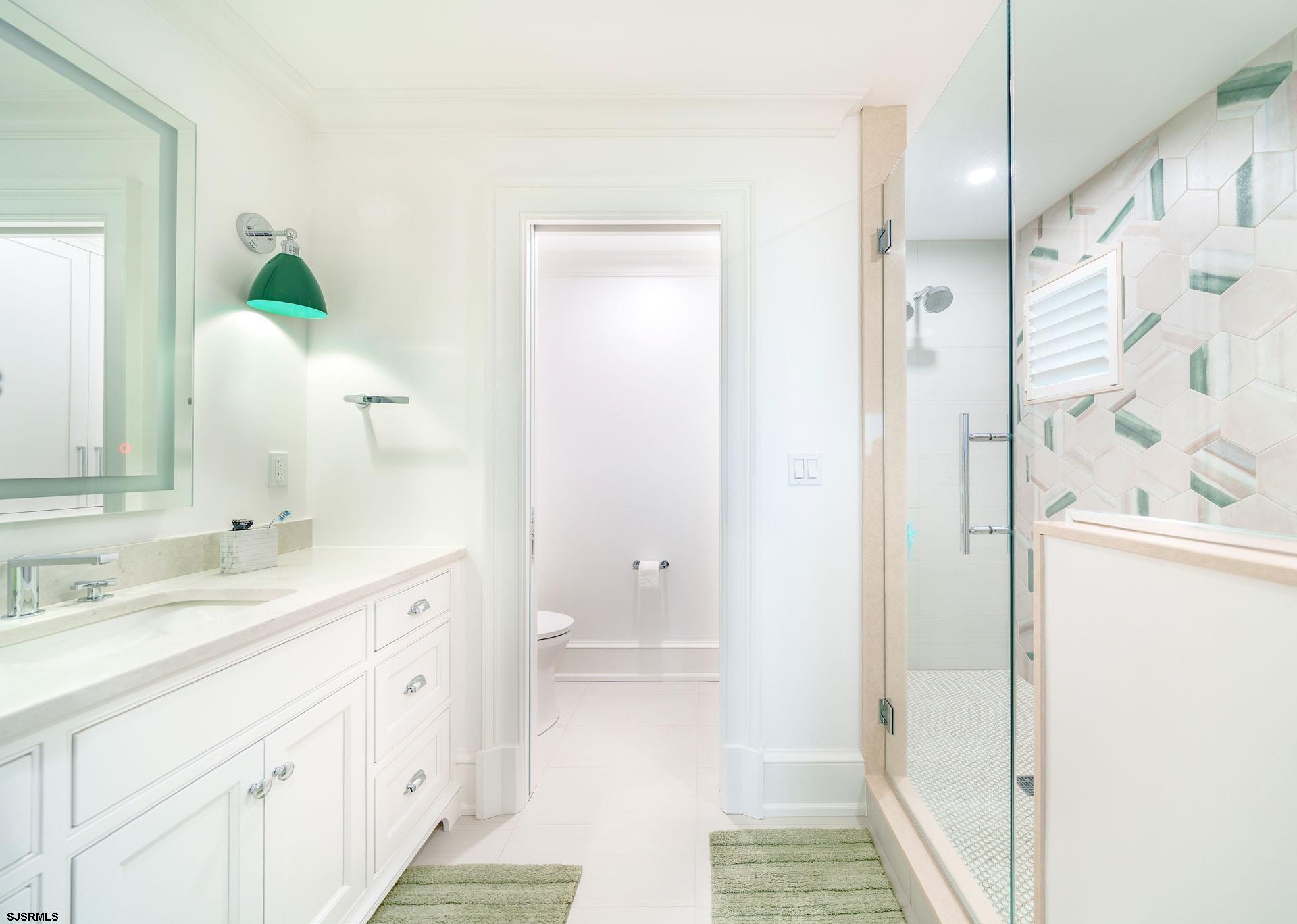 55 Walnut Road Ocean City, NJ 08226 - Photo 50 of 97 a bathroom with a double vanity sink and mirror