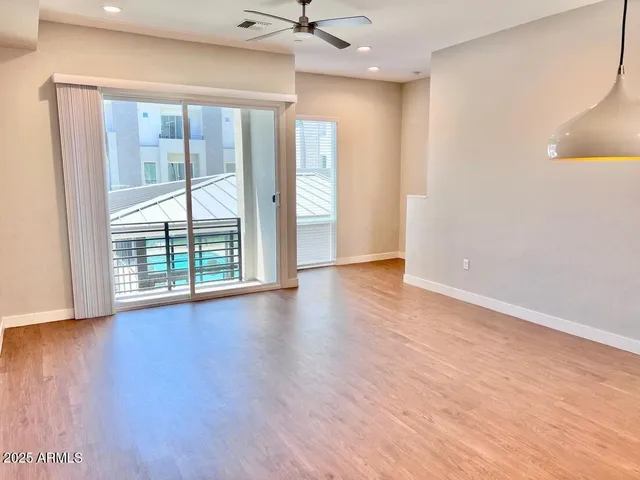 wooden floor in an empty room with a window