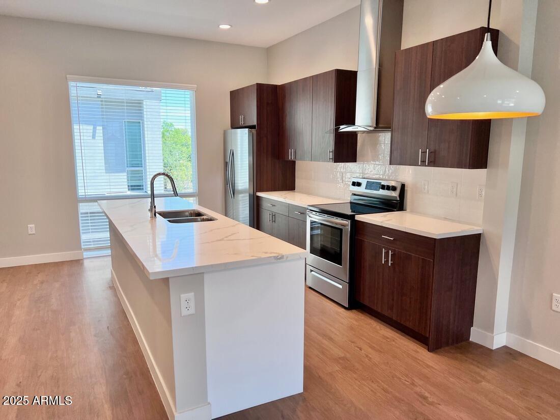 915 East Missouri Avenue, Unit 10 Phoenix, AZ 85014 - Photo 2 of 61 a kitchen with stainless steel appliances granite countertop a sink a stove and a refrigerator