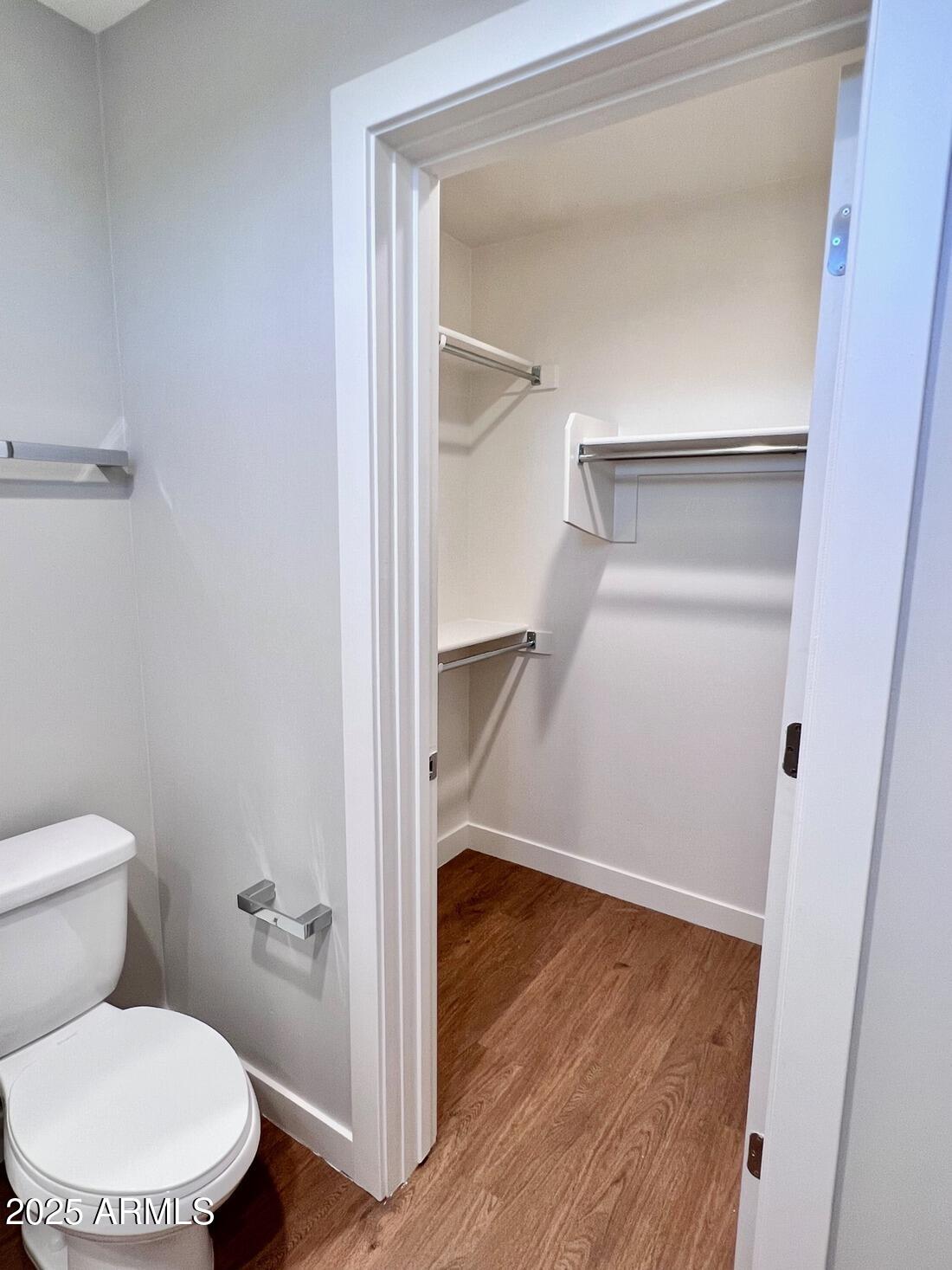 915 East Missouri Avenue, Unit 10 Phoenix, AZ 85014 - Photo 22 of 61 a bathroom with a toilet and a wooden floor