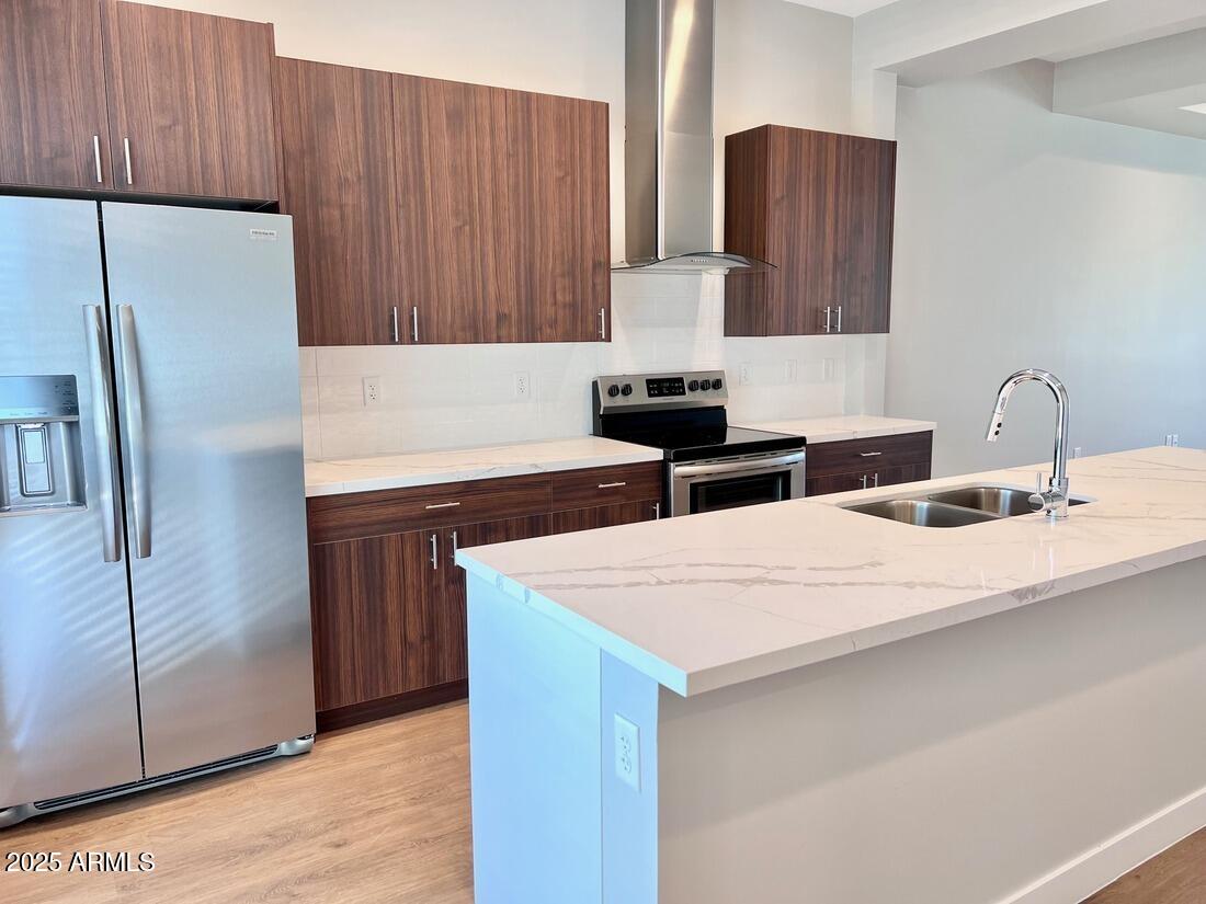 915 East Missouri Avenue, Unit 10 Phoenix, AZ 85014 - Photo 4 of 61 a kitchen with stainless steel appliances a refrigerator and a sink