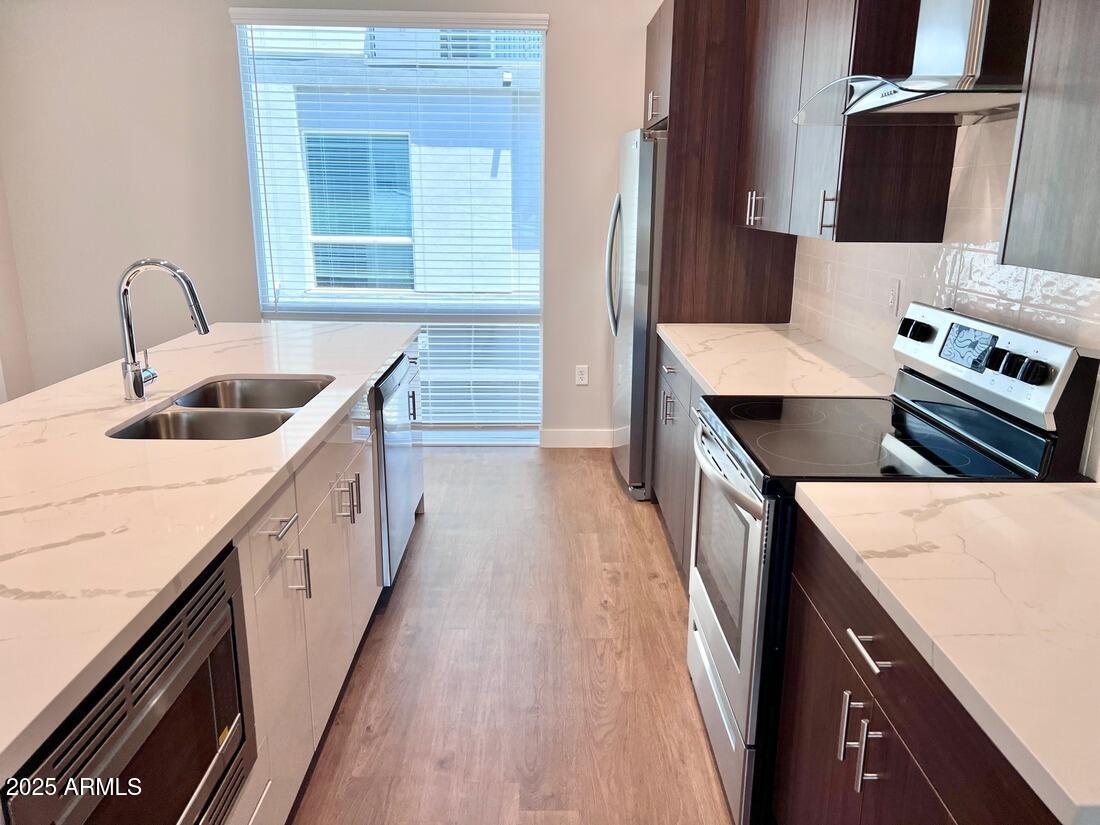915 East Missouri Avenue, Unit 10 Phoenix, AZ 85014 - Photo 6 of 61 a kitchen with a stove and a sink