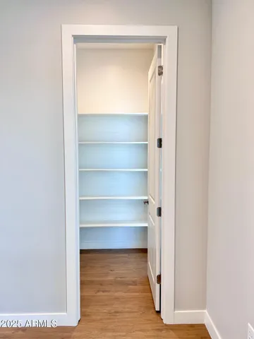 a view of walk in closet with empty racks