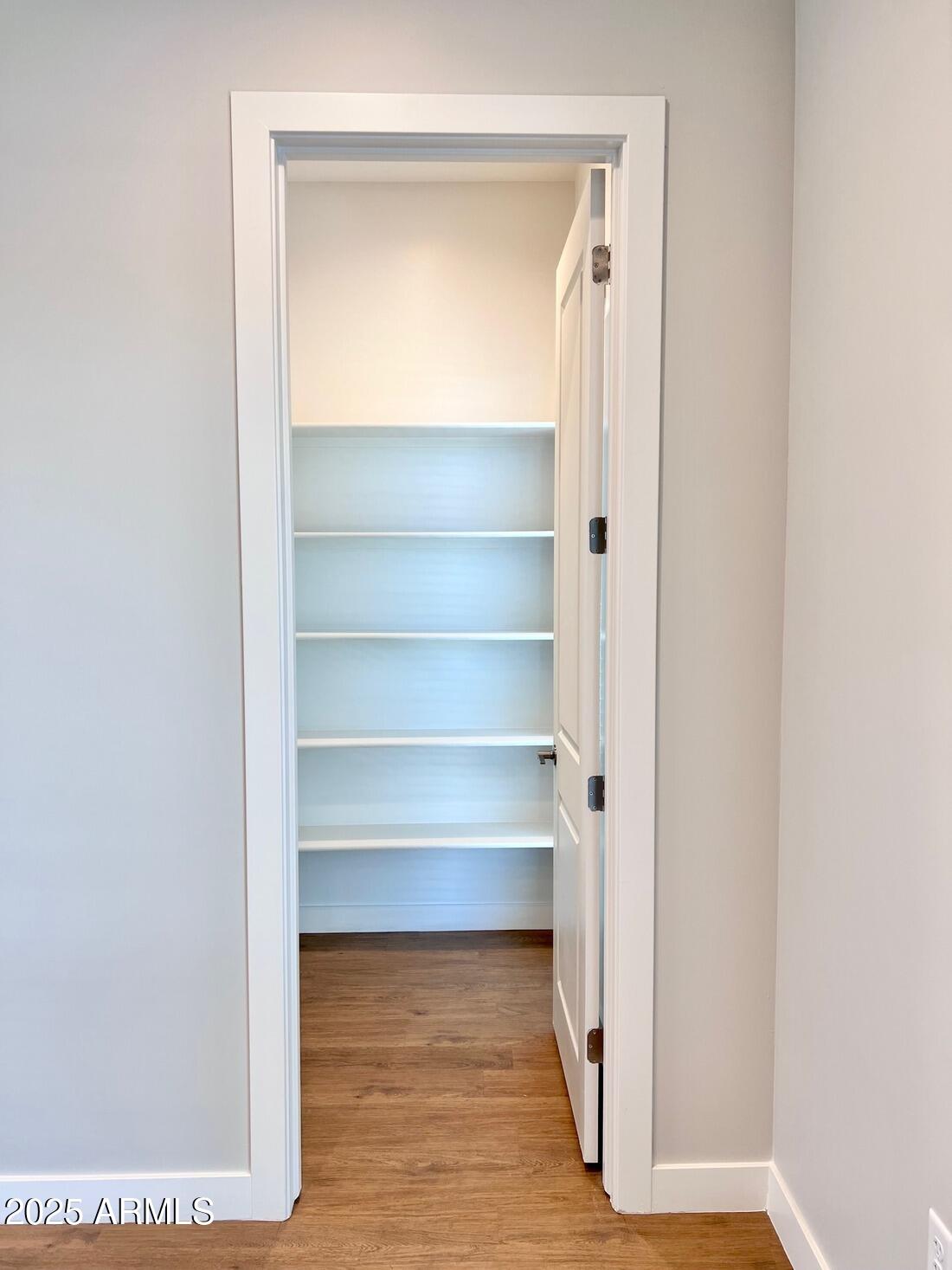 915 East Missouri Avenue, Unit 10 Phoenix, AZ 85014 - Photo 8 of 61 a view of walk in closet with empty racks