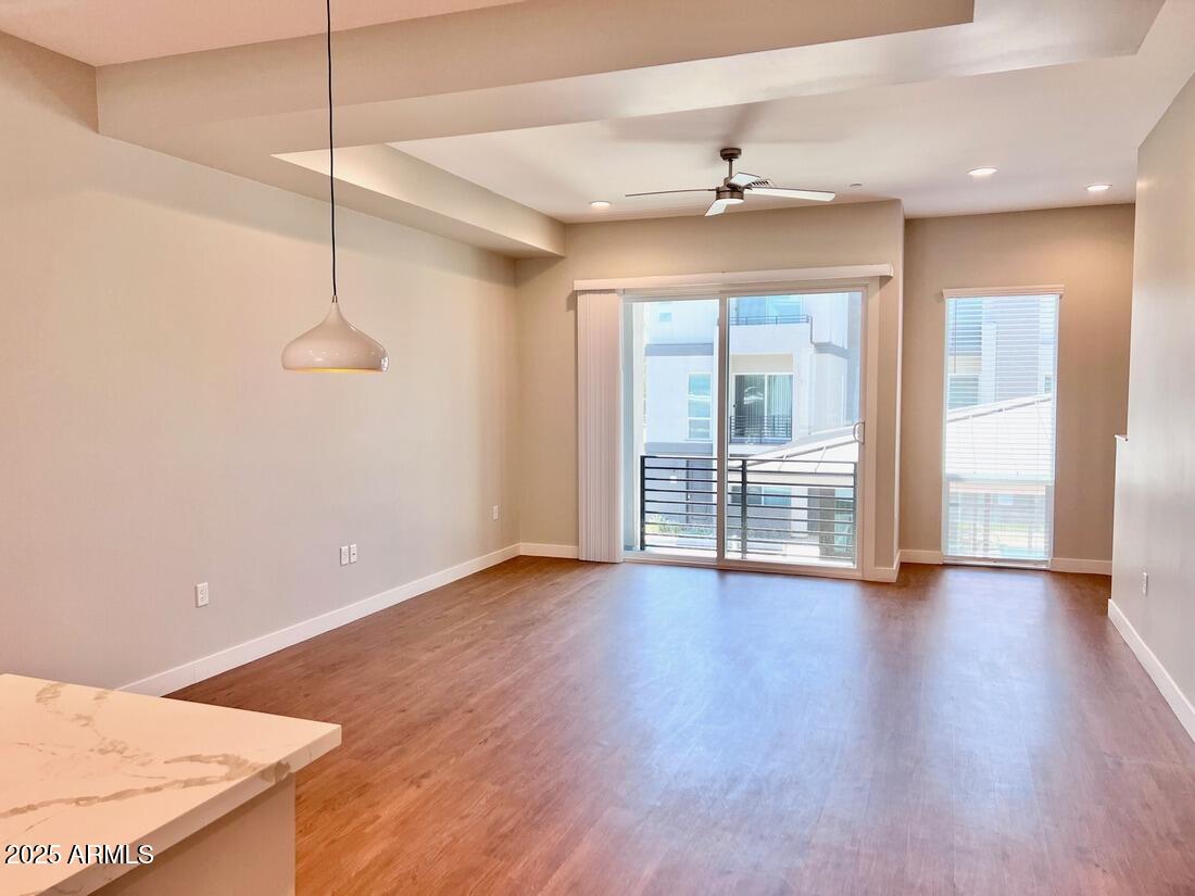 915 East Missouri Avenue, Unit 10 Phoenix, AZ 85014 - Photo 10 of 61 a view of an empty room with wooden floor and a window