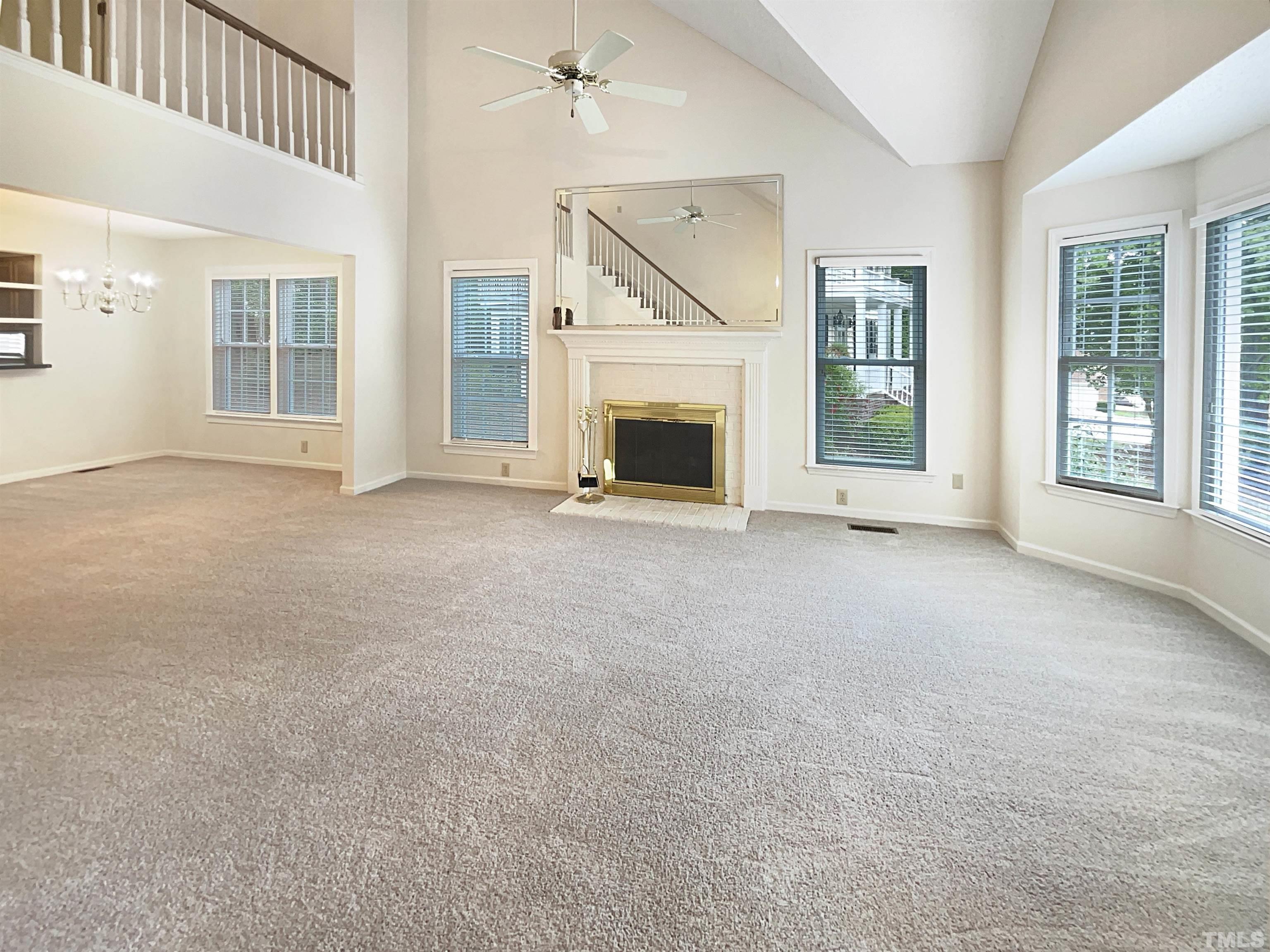 1749 Kingston Heath Way Raleigh, NC 27604 - Photo 3 of 19 a view of a livingroom with an empty space and a fireplace