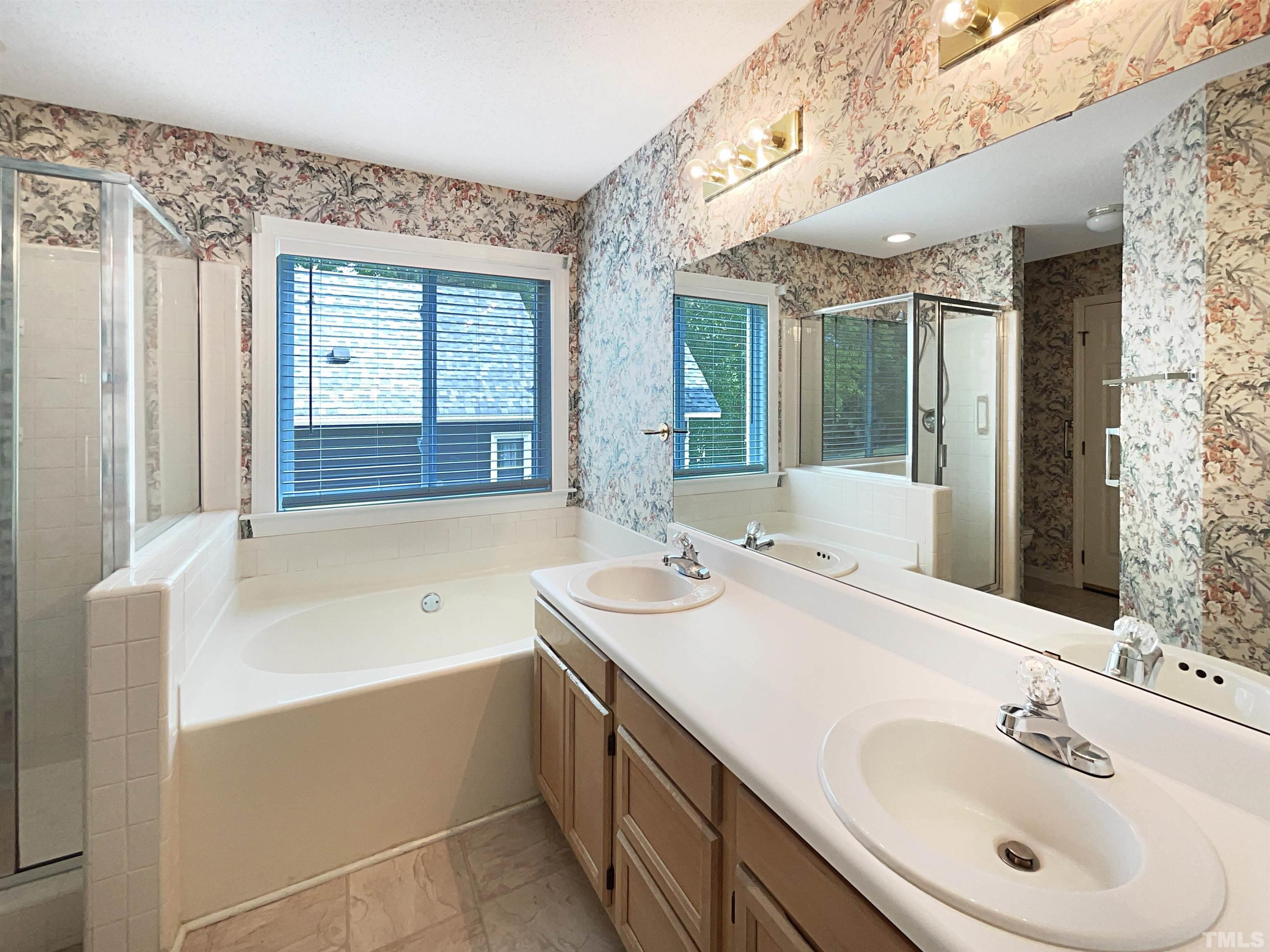 1749 Kingston Heath Way Raleigh, NC 27604 - Photo 4 of 19 a bathroom with a tub sink and mirror