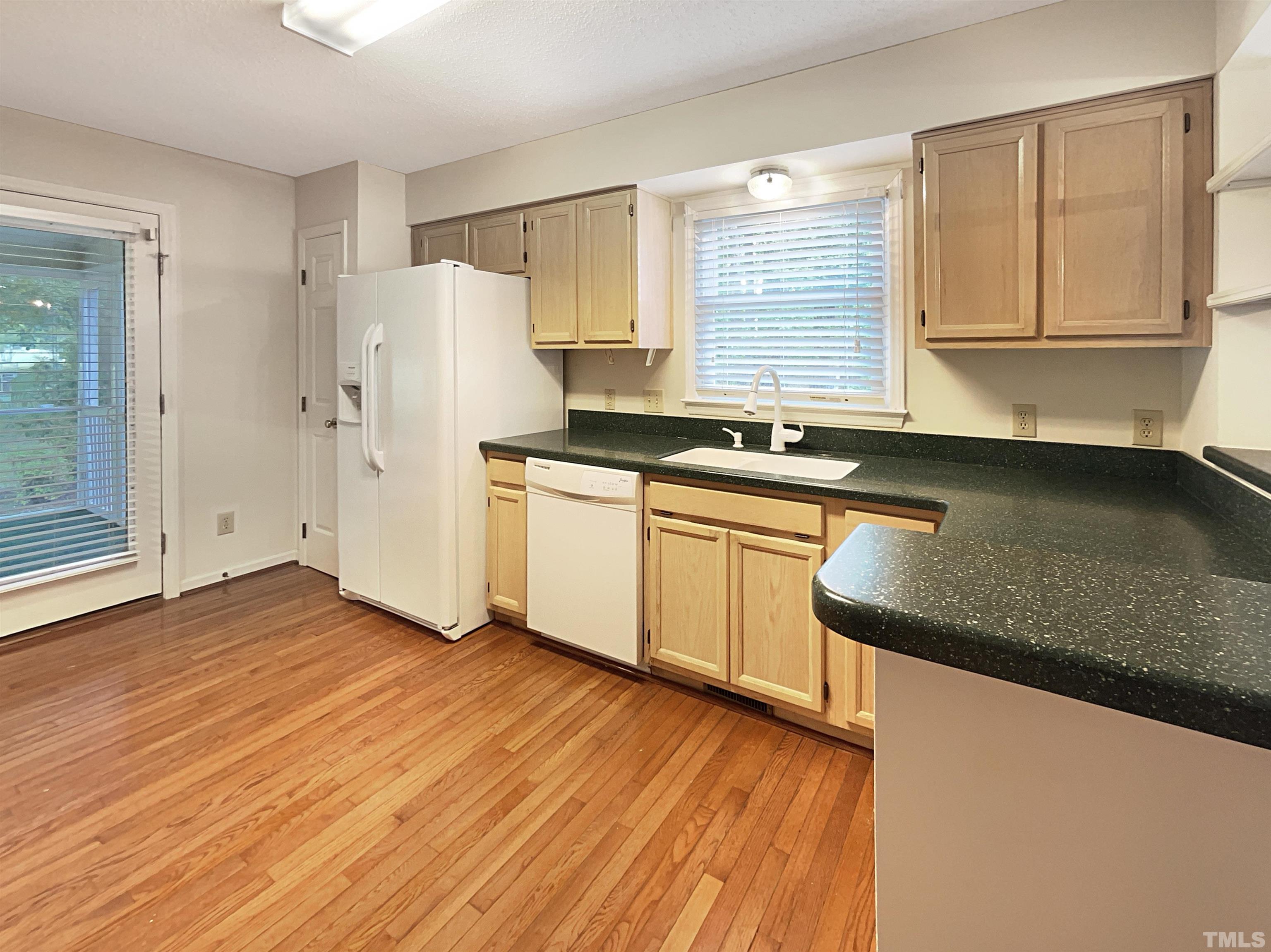 1749 Kingston Heath Way Raleigh, NC 27604 - Photo 10 of 19 a kitchen with granite countertop a sink a stove and refrigerator
