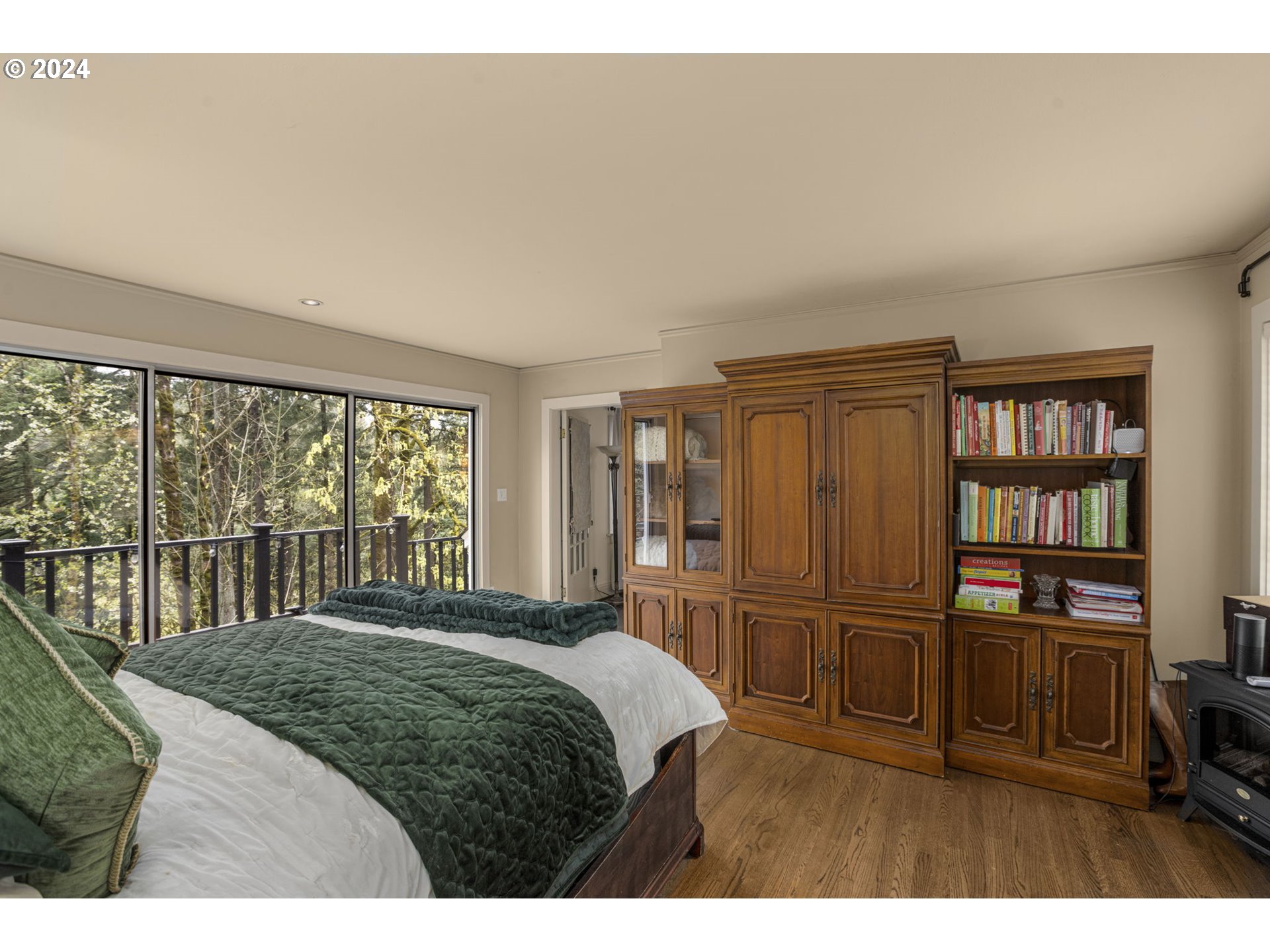 2271 Southwest Montgomery Drive Portland, OR 97201 - Photo 10 of 25 a bedroom with a bed a table and a large window