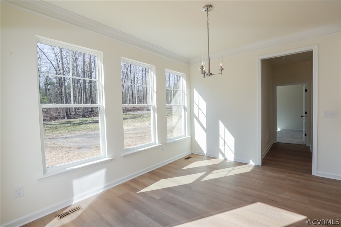 3825 Belspring Road Chester, VA 23831 - Photo 16 of 48 a view of an empty room with wooden floor and a window