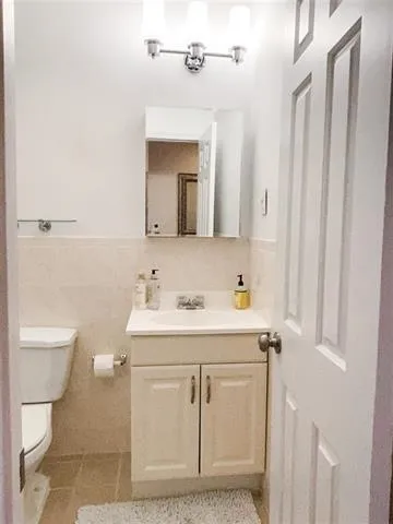 a bathroom with a sink a toilet and a mirror