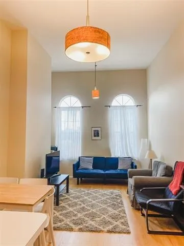 a living room with furniture and a chandelier