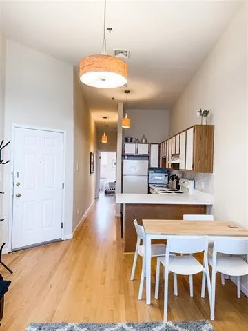 a view of a kitchen with dining table and chairs