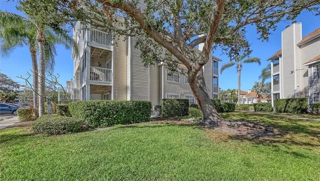 a front view of a house with a yard and a garden