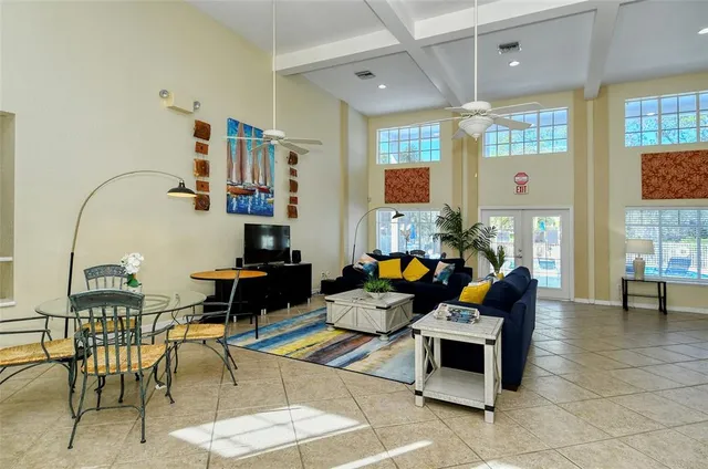 a living room with lots of furniture and a chandelier