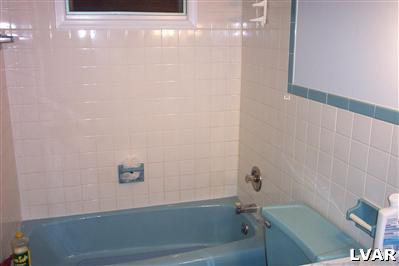 Main bath, tiled, toilet insides "as is"
