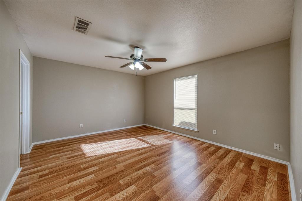 771 Olive Branch Road Weatherford, TX 76087 - Photo 17 of 20 a view of an empty room with wooden floor and a window
