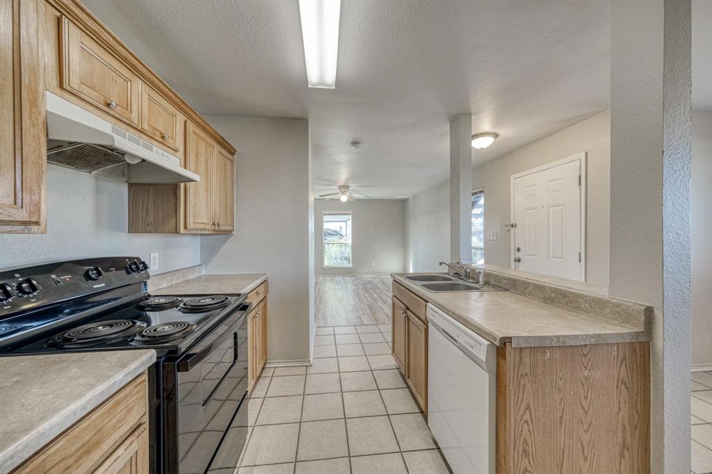 771 Olive Branch Road Weatherford, TX 76087 - Photo 2 of 20 a kitchen that has a sink and a stove