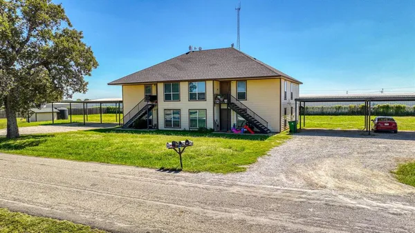 a view of a house with a yard and plants