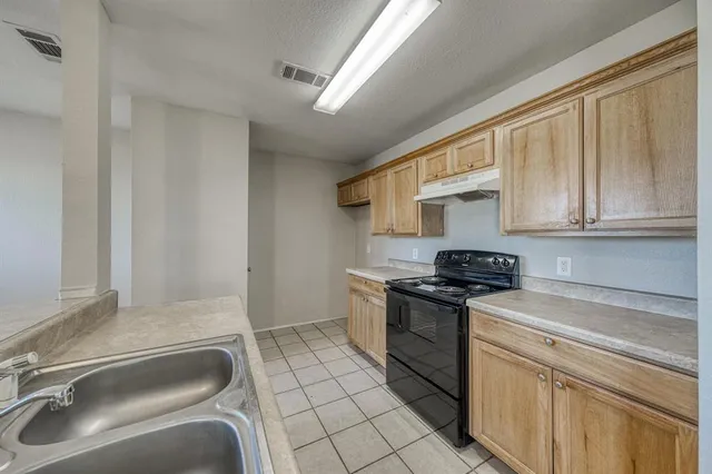 a kitchen with a sink appliances and cabinets
