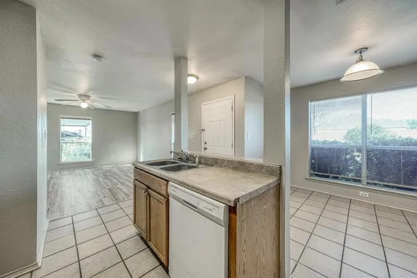 a kitchen with a sink a counter space and a window
