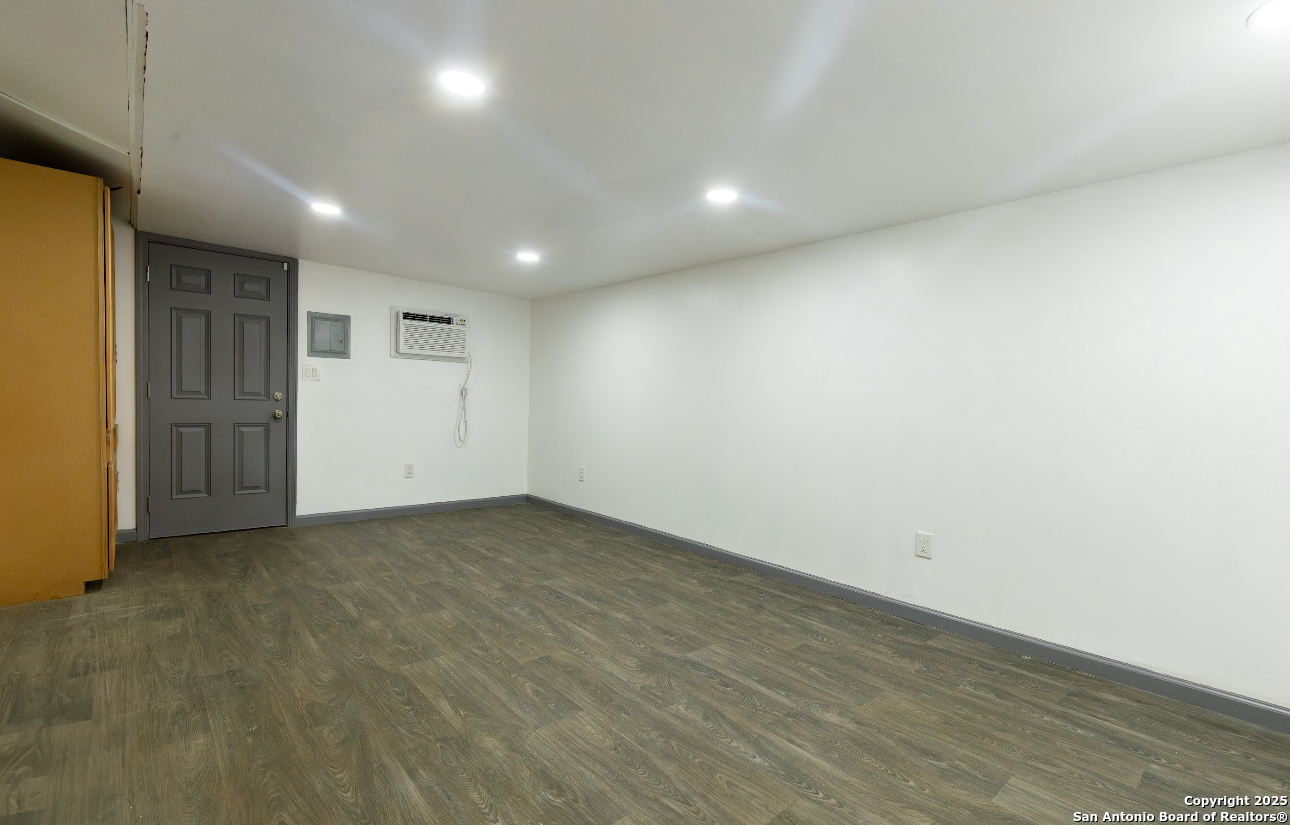 1510 Corgey Road Pleasanton, TX 78064 - Photo 20 of 34 an empty room with wooden floor and natural light