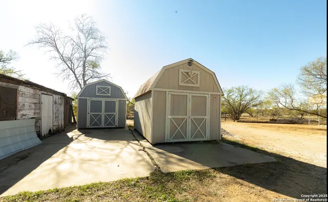 a view of a wooden house with a yard