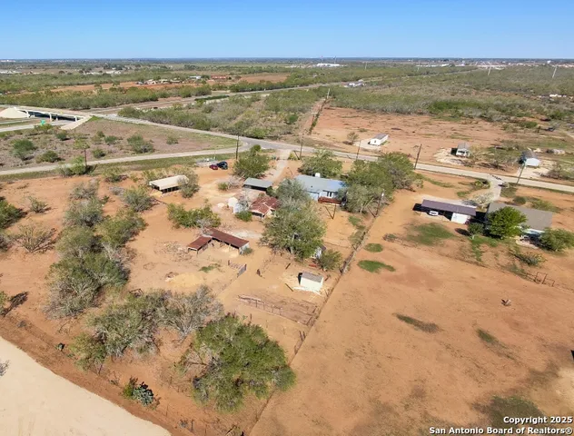an aerial view of residential houses with outdoor space