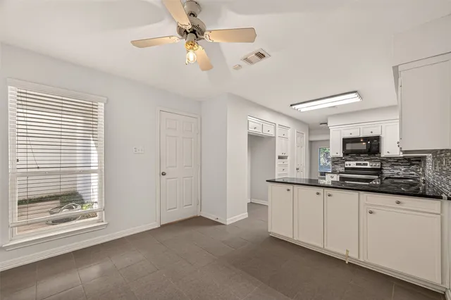 a kitchen with stainless steel appliances a sink a stove and cabinets