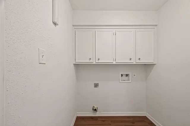 a view of a closet with white cabinets