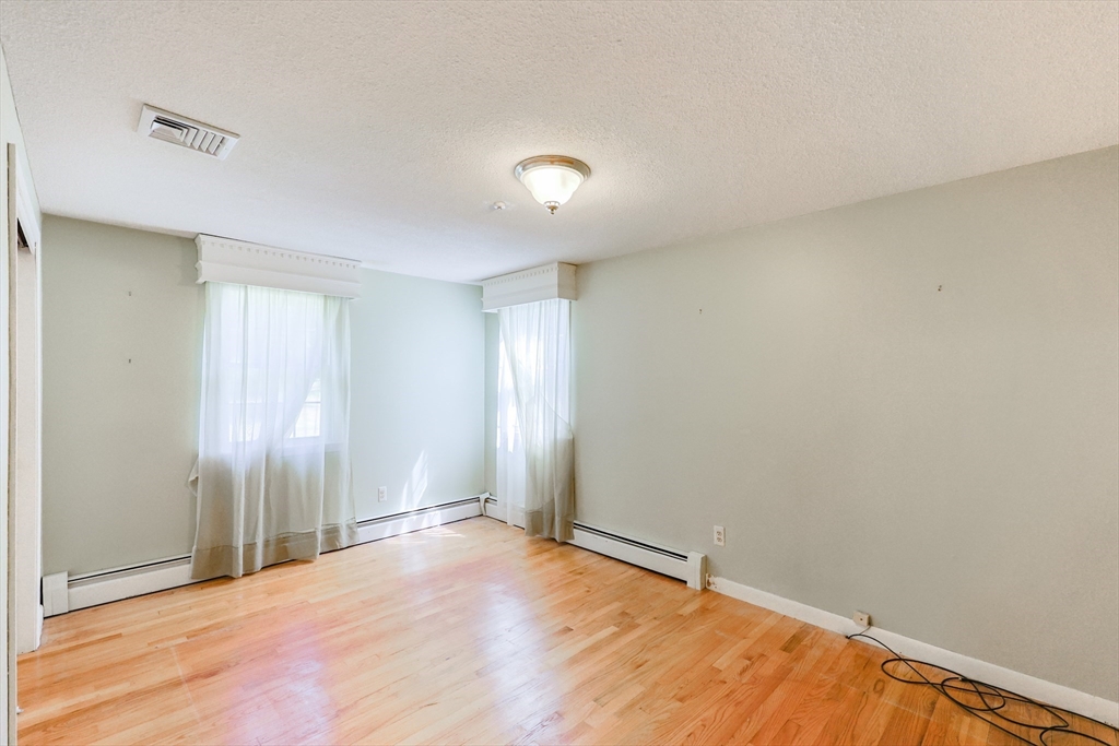37 Oakleaf Drive Mansfield, MA 02048 - Photo 11 of 36 an empty room with wooden floor and windows