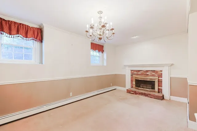 a view of livingroom with fireplace chandelier and window