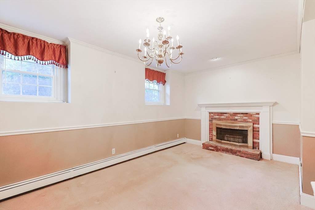 37 Oakleaf Drive Mansfield, MA 02048 - Photo 19 of 36 a view of livingroom with fireplace chandelier and window