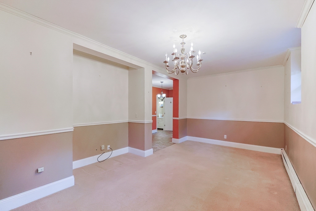37 Oakleaf Drive Mansfield, MA 02048 - Photo 20 of 36 a view of an empty room with chandelier and a window