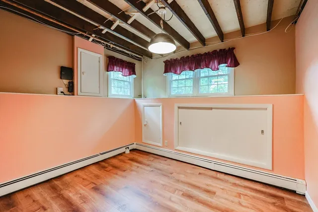 a view of a room with wooden floor