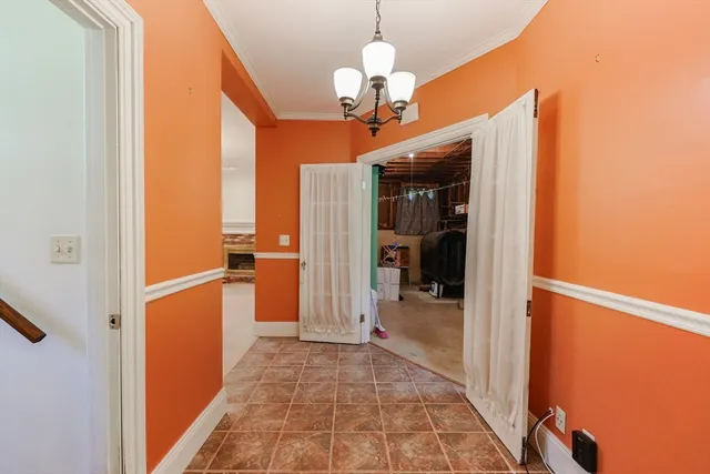 a view of a hallway with a dining table
