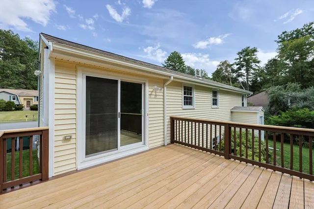 a view of backyard with deck and wooden floor