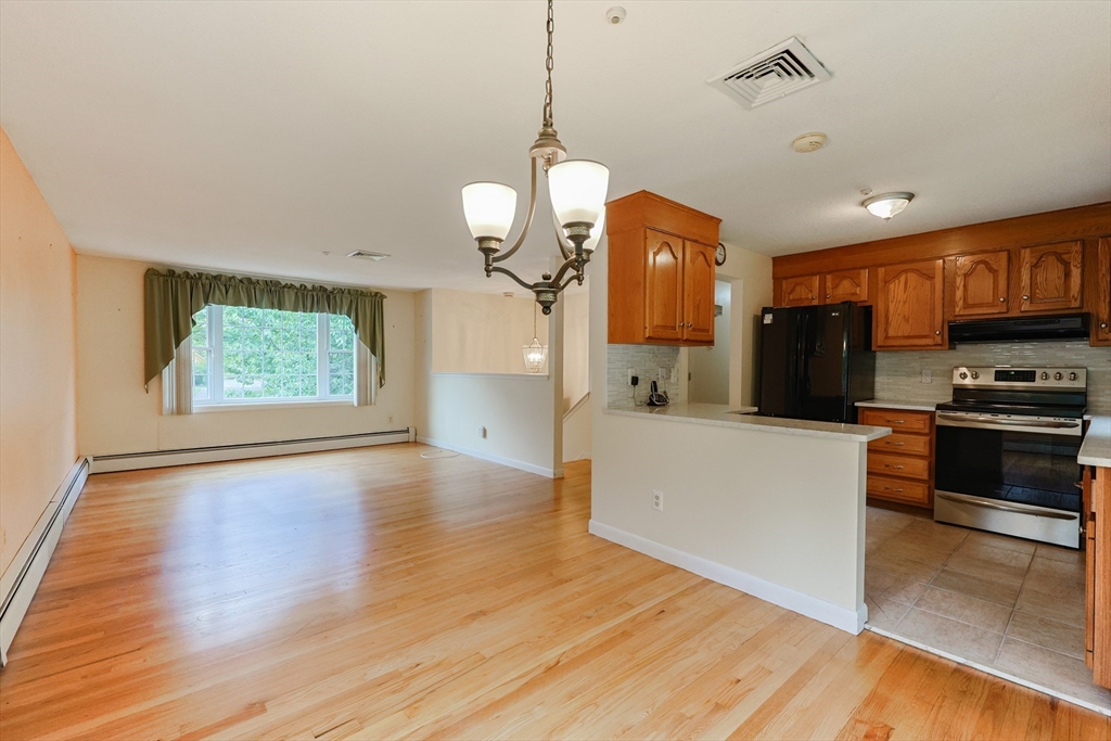 37 Oakleaf Drive Mansfield, MA 02048 - Photo 5 of 36 a view of a kitchen with a stove wooden cabinets and entryway
