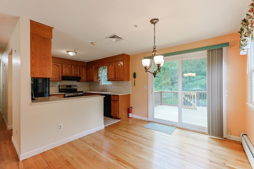 37 Oakleaf Drive Mansfield, MA 02048 - Photo 6 of 36 a kitchen with stainless steel appliances granite countertop a refrigerator a sink dishwasher a stove and a dining table with wooden floor