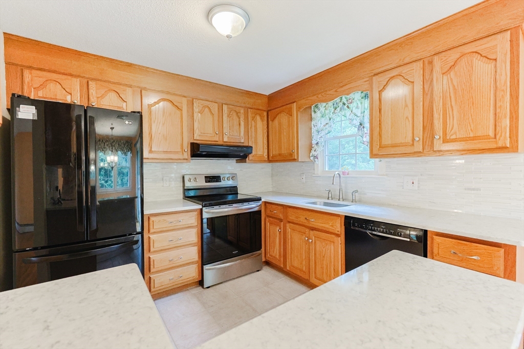 37 Oakleaf Drive Mansfield, MA 02048 - Photo 7 of 36 a kitchen with stainless steel appliances granite countertop a stove a sink dishwasher and a refrigerator
