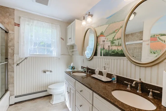a bathroom with a double vanity sink and a mirror
