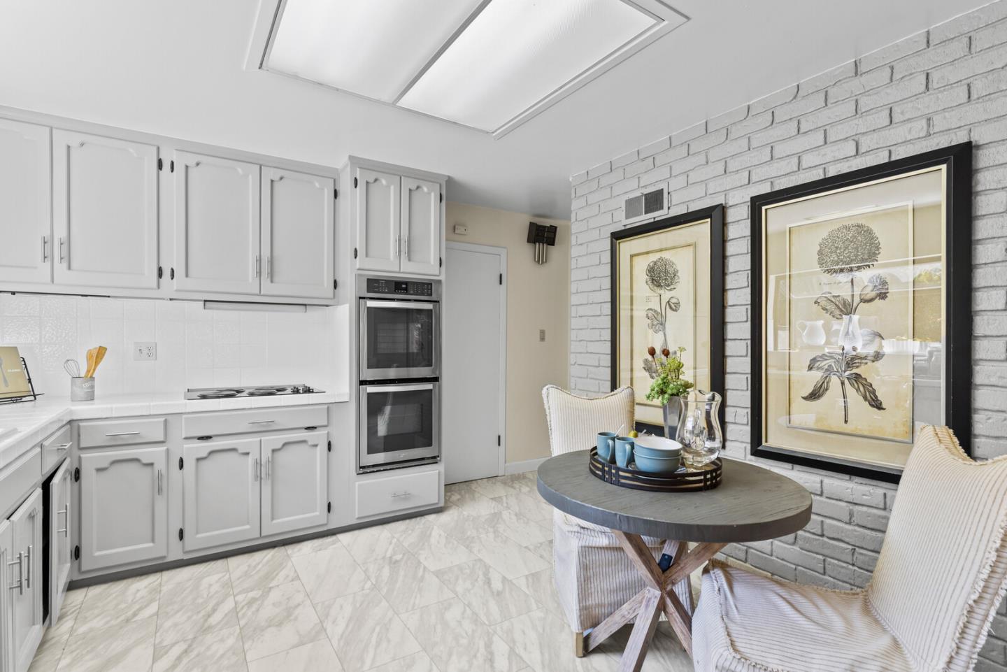 100 Parkview Drive San Bruno, CA 94066 - Photo 12 of 25 a kitchen with stainless steel appliances kitchen island a table and chairs in it