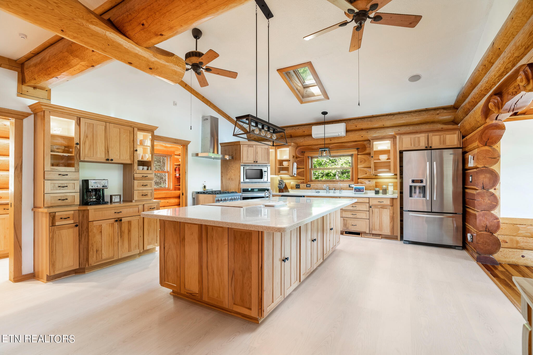 546 Bluff View Road New Tazewell, TN 37825 - Photo 10 of 60 a kitchen with stainless steel appliances kitchen island granite countertop a table chairs stove and cabinets